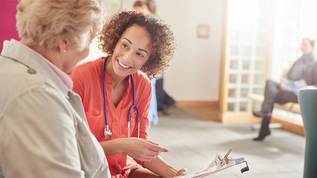 A female doctor helping a patient